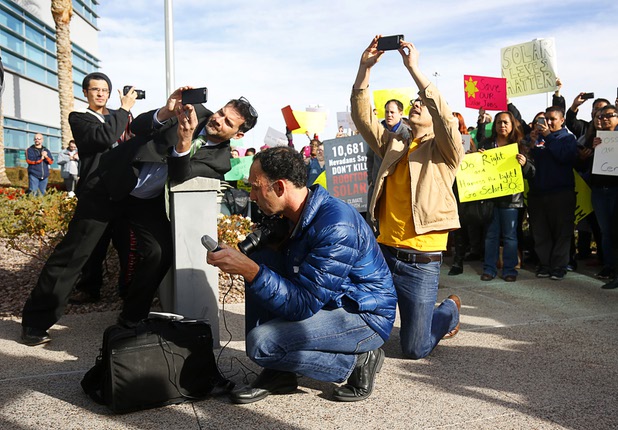 People take photos and video as actor Mark Ruffalo rallies solar supporters in front of Public Utilities Commission offices Wednesday, Jan 13, 2016.