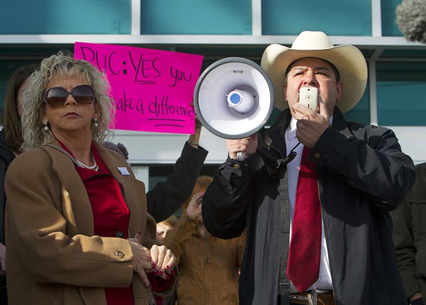Debbie Dooley, left, founder of Conservatives for Energy Freedom, and Scott LaFata rally solar supporters in front of Public Utilities Commission offices Wednesday, Jan 13, 2016.