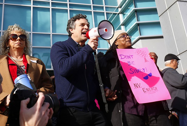 Actor Mark Ruffalo, center, rallies solar supporters in front of Public Utilities Commission offices Wednesday, Jan 13, 2016. Debbie Dooley, founder of Conservatives for Energy Freedom, stands by at left.