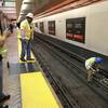 A BART worker destroys a faulty insulator with a sledgehammer, right, Friday, Feb. 13, 2015, at the Powell Street station in San Francisco. 