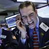 Stock trader Gregory Rowe works at the New York Stock Exchange, Friday, Jan. 15, 2016.