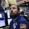 Michael Pistillo Jr. follows stock prices at the New York Stock Exchange, Friday, Jan. 15, 2016.