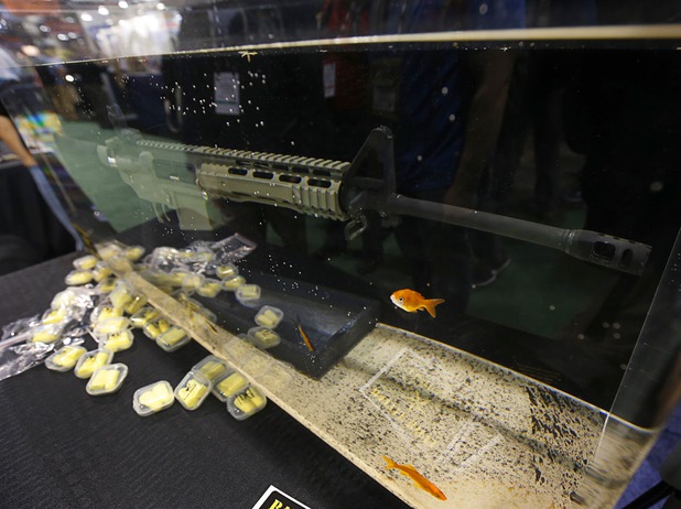 A BR4 Trident rifle is shown in an aquarium at the Battle Rifle Company booth during the SHOT (Shooting, Hunting and Outdoor Trade) Show at the Sands Expo Tuesday, Jan. 19, 2016. The weapon is coated with a special rust-proof coating, a representative said.