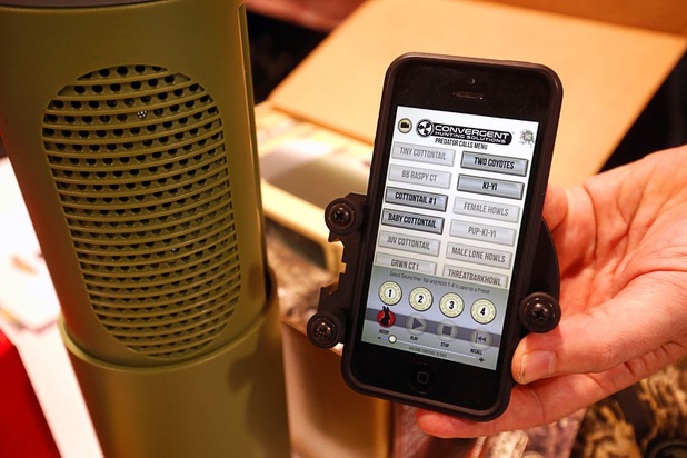Animal calls are shown on a smartphone next to a bullet shaped Bluetooth speaker during the SHOT (Shooting, Hunting and Outdoor Trade) Show at the Sands Expo Tuesday, Jan. 19, 2016.  The BulletHP Game Calling System comes with a mount to attach the smartphone to a rifle and a carry care for the speaker.