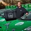 Kian Salehi is a Bite Squad co-founder and relaxes near a fleet of their delivery cars on Tuesday, January 19, 2016.