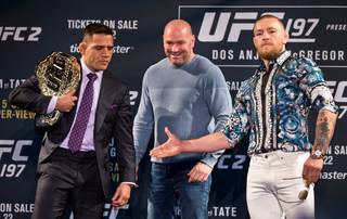 UFC 197 fighter Rafael dos Anjos looks with disdain to Conor McGregor’s hand after facing off between UFC President Dana White on Wednesday, Jan. 20, 2016, at MGM Grand. The two joined a press conference featuring Holly Holm and Miesha Tate at MGM Grand.