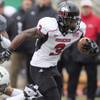 In this Nov. 23, 2012, file photo, Northern Illinois' Akeem Daniels (3) breaks a tackle during an NCAA football game against Eastern Michigan in Ypsilanti, Mich. The former NIU running back filed a lawsuit in Chicago on Wednesday, Jan. 27, 2016, suing two daily fantasy sports sites, Boston-based DraftKings and New York-based FanDuel, alleging that they used his name to generate millions of dollars in revenue.