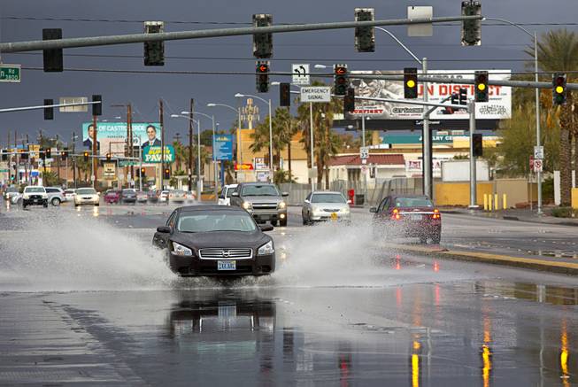 A motorist drives through rain run-off on Valley View Boulevard near Spring Mountain Road on Sunday, Jan. 31, 2016. 