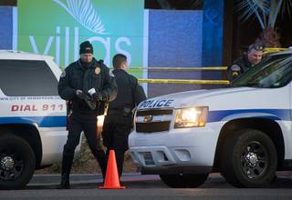 Henderson Police officers investigate a fatal shooting at the entrance to the Villas at Green Valley apartment complex at Green Valley Parkway and Mesa Drive Monday, Feb. 1, 2016.