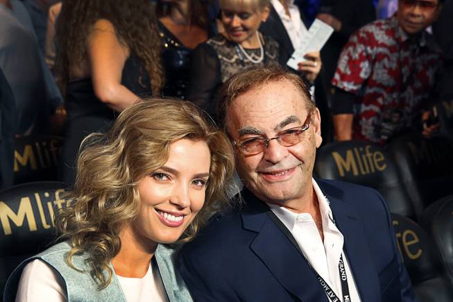 Casino owner Phil Ruffin and his wife Oleksandra Nikolayenko wait for the start of the Floyd Mayweather Jr vs. Marcos Maidana fight at the MGM Grand Garden Arena Saturday, Sept. 13, 2014.
