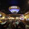 In this Wednesday, Feb. 3, 2016 photo patrons play poker in a designated area at Twin River Casino, in Lincoln, R.I. Casinos far from Las Vegas are experimenting with different ways to draw millennials. Twin River Casino removed 274 slot machines to make way in December for more poker and other table games favored by younger gamblers. 