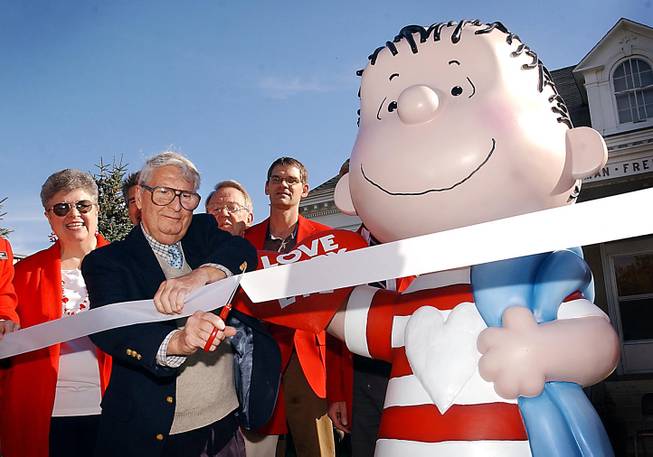 In a Sept. 23, 2003, file photo, the real Linus, artist Linus Maurer, cuts a ribbon after unveiling a statue of Linus of "Peanuts" fame during a ceremony at his hometown of Sleepy Eye, Minn. Maurer, a cartoonist and illustrator whose old friend Charles Schulz borrowed his first name for Charlie Brown’s sidekick, has died. 