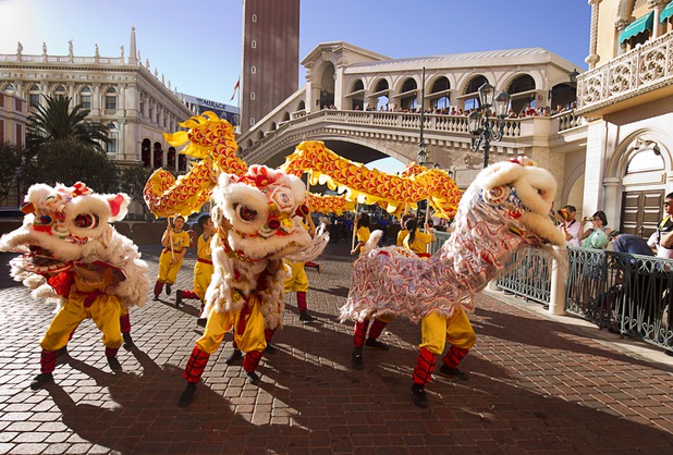Lion and dragon dancers perform in front of the Venetian during Chinese New Year celebrations at the Venetian and Palazzo Monday, Feb. 8, 2016. The Chinese New Year, the Year of the Monkey, began Monday.