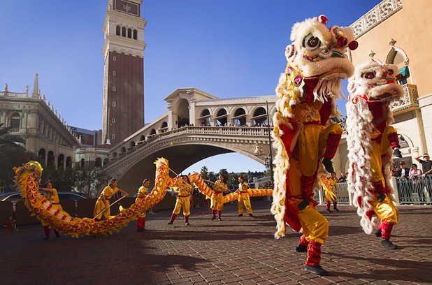 Lion and dragon dancers perform in front of the Venetian during Chinese New Year celebrations at the Venetian and Palazzo Monday, Feb. 8, 2016. The Chinese New Year, the Year of the Monkey, began Monday.