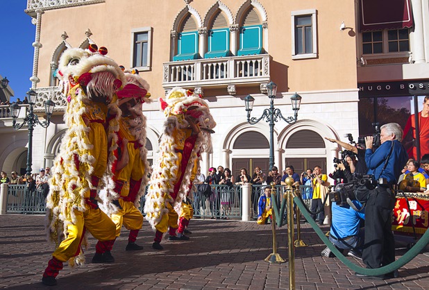 Photographers take pictures of lion dancers in front of the Venetian during Chinese New Year celebrations at the Venetian and Palazzo Monday, Feb. 8, 2016. The Chinese New Year, the Year of the Monkey, began Monday.