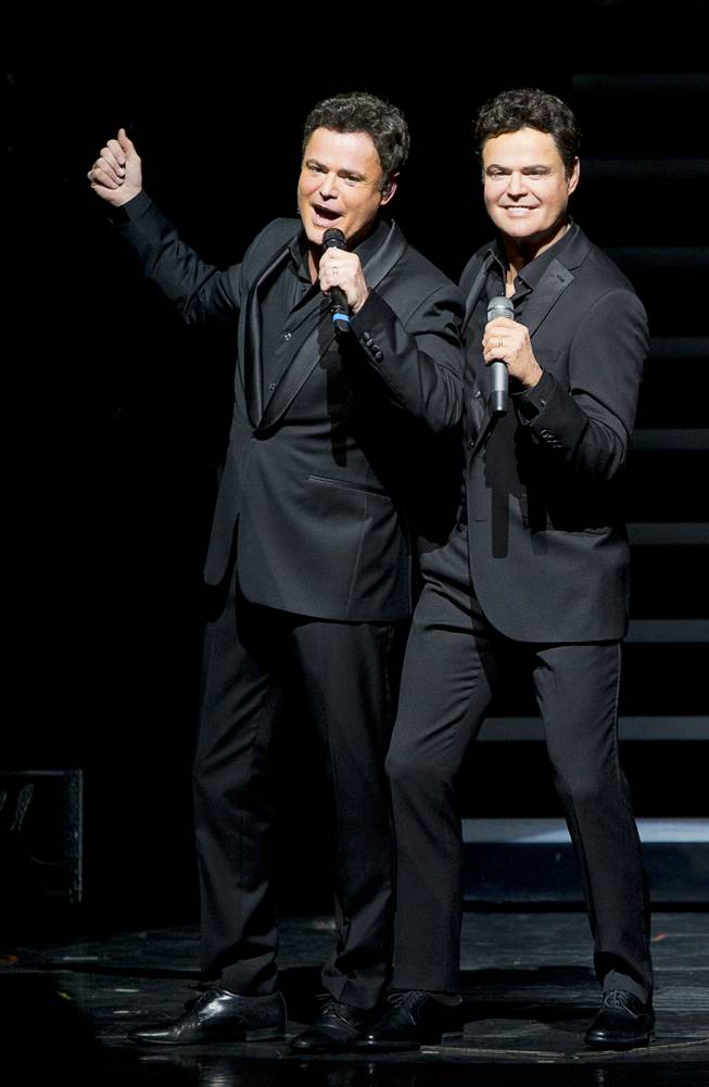 Donny Osmond, left, poses by a Madame Tussauds wax figure of himself as Donny and Marie wax figures are unveiled during Donny & Marie show at the Flamingo Tuesday, Feb. 9, 2016. The figures will be permanently on display inside Madame Tussauds Las Vegas located in the Venetian.