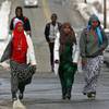 In this Tuesday, Jan. 26, 2016, photo, students walk home from school in Lewiston, Maine. Since February 2000, more than 5,000 Africans have come to Lewiston, a city of 36,500. Fifteen years later, Somali shops, restaurants and mosques serve as an example of how far Lewiston has come. 