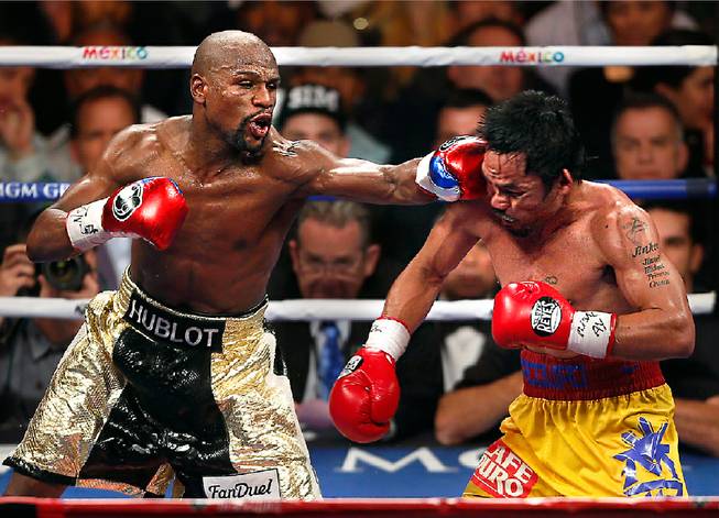 Floyd Mayweather connects to the chin of Manny Pacquiao during their fight at the MGM Grand Garden Arena on Saturday, May 2, 2015.