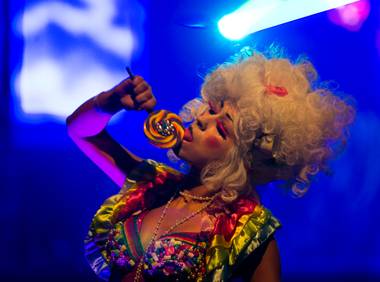A dancer performs with lollipop in Creepy Hollow at the start of the Fetish & Fantasy Halloween Ball at the Hard Rock Hotel and Casino Friday, October 26, 2013.