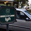In this Jan. 14, 2016, photo, a driver waits to pick up passengers at an Uber and Lyft pickup area at the Bellagio in Las Vegas.
