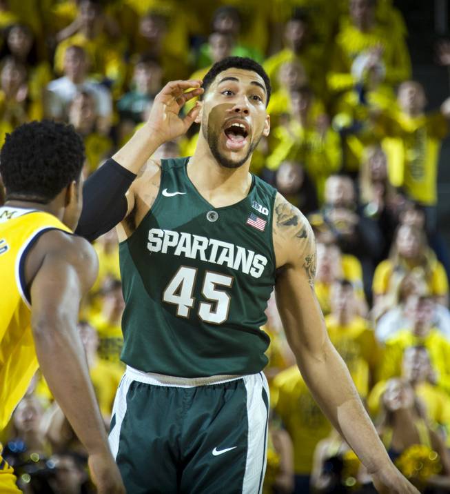Michigan State guard Denzel Valentine (45) shouts to his teammates while dribbling in the first half of an NCAA college basketball game against Michigan at Crisler Center in Ann Arbor, Mich., Saturday, Feb. 6, 2016
