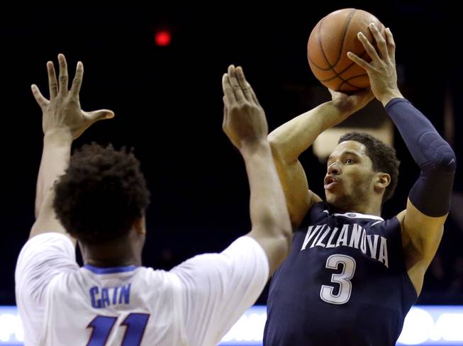 Villanova guard Josh Hart, right, shoots over DePaul guard Eli Cain during the first half of an NCAA college basketball game Tuesday, Feb. 9, 2016, in Rosemont, Ill.