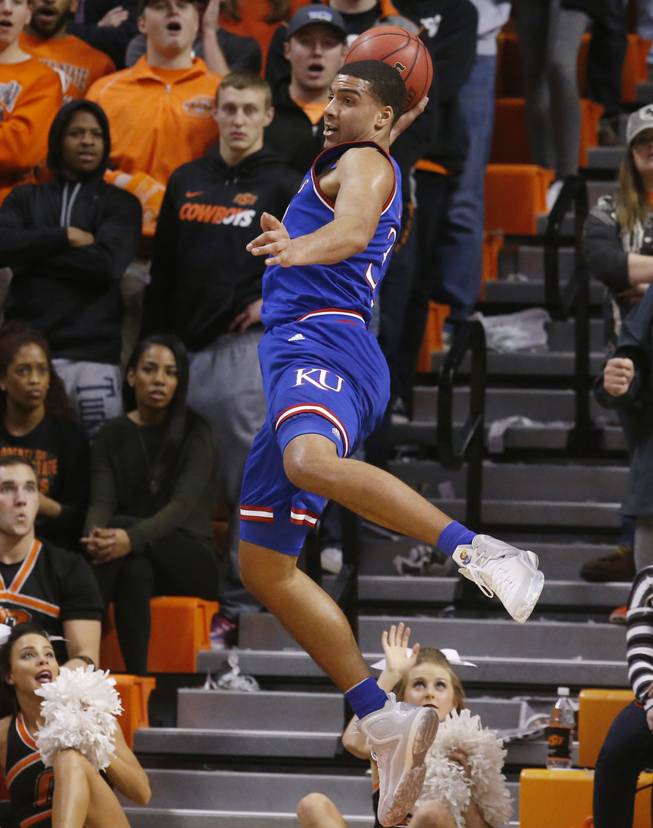Kansas forward Landen Lucas keeps the ball in bounds in the first half of an NCAA college basketball game against Oklahoma State in Stillwater, Okla., Tuesday, Jan. 19, 2016.
