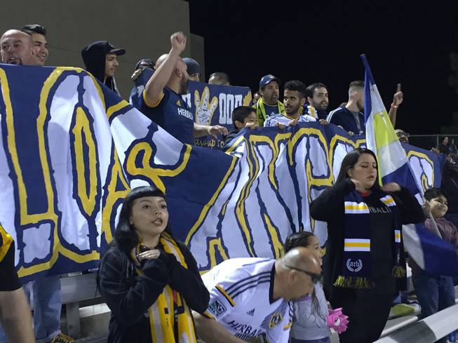 Fans from the Los Angeles Galaxy's Angel City Brigade hold a sign during the second half of an MLS exhibition match Saturday, Feb. 13, 2016, at Cashman Field.