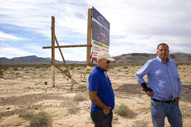 Real estate investors Ben Raffi, left, and Ron Hakakian of Los Angeles look over land near Interstate 15 and Highway 93, north of Las Vegas Wednesday, Feb. 17, 2016. Electric car start-up Faraday Future plans to build a $1 billion auto plant in the Apex Industrial Park.