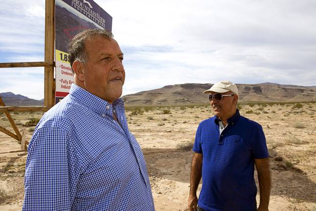 Real estate investors Ron Hakakian, left, and Ben Raffi of Los Angeles look over land near Interstate 15 and Highway 93, north of Las Vegas Wednesday, Feb. 17, 2016. Electric car start-up Faraday Future plans to build a $1 billion auto plant in the Apex Industrial Park.