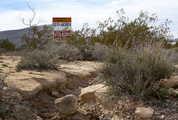 A sign advertises industrial land near Interstate 15 and Highway 93, north of Las Vegas Wednesday, Feb. 17, 2016. Electric car start-up Faraday Future plans to build a $1 billion auto plant in the Apex Industrial Park.