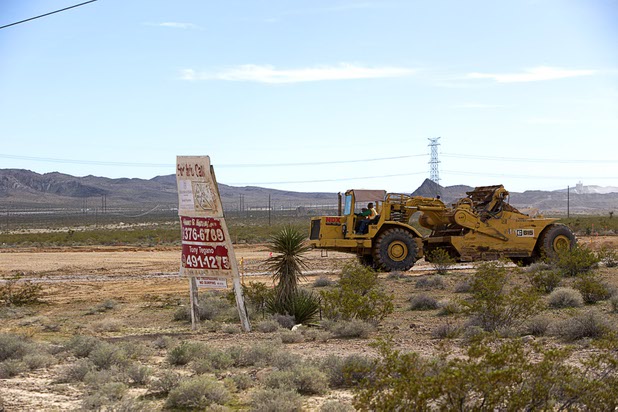 An earthmover works a site being prepared for a medical marijuana complex in the in the Apex Industrial Park near Interstate 15 and Highway 93, north of Las Vegas Wednesday, Feb. 17, 2016. Electric car start-up Faraday Future plans to build a $1 billion auto plant in the park.