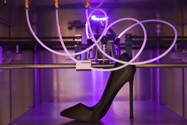 A 3D printed show is displayed in a Blue Dragon Fire Print KH-1728 3D printer during the Magic fashion convention at the Las Vegas Convention Center Thursday, Feb. 18, 2016.