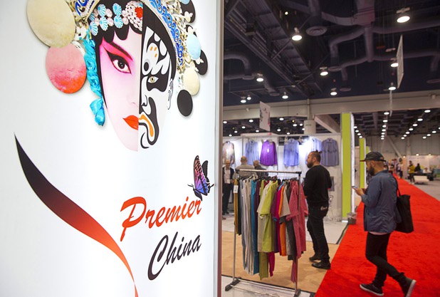 People walk through booths featuring goods from Chinese factories during the Magic fashion convention at the Las Vegas Convention Center Thursday, Feb. 18, 2016.