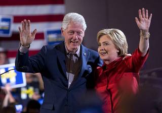 Former President Bill Clinton and Democratic presidential candidate Hillary Clinton wave after Hillary Clinton's victory speech at Caesars Palace Saturday, Feb. 20, 2016.