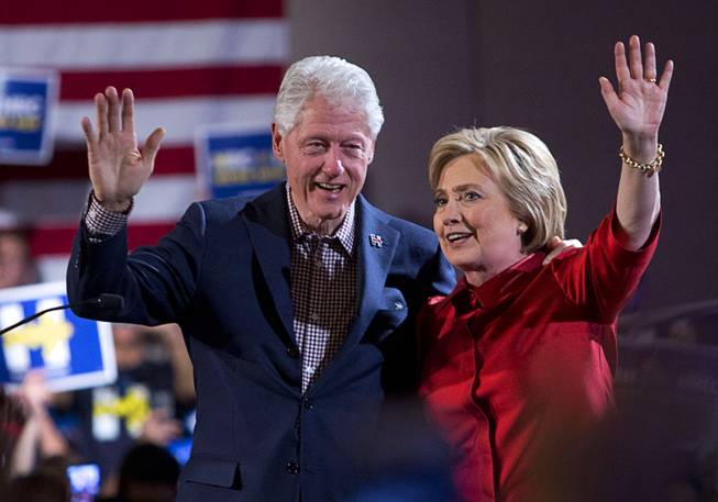 Former President Bill Clinton and Democratic presidential candidate Hillary Clinton wave after Hillary Clinton's victory speech at Caesars Palace following the Nevada caucuses Saturday, Feb. 20, 2016.