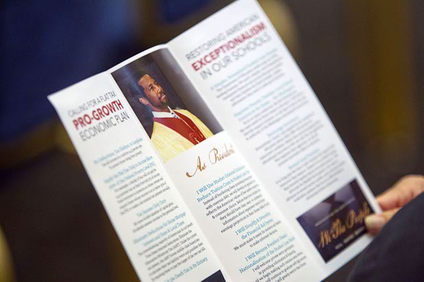 A couple look over a pamphlet on Republican presidential candidate Ben Carson before Carson's campaign stop at the Mountain Shadows Community Center in Summerlin Tuesday, Feb. 23, 2016.