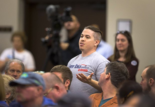 A man asks Republican presidential candidate Ben Carson about the cost of child care during a campaign stop at the Mountain Shadows Community Center in Summerlin Tuesday, Feb. 23, 2016.