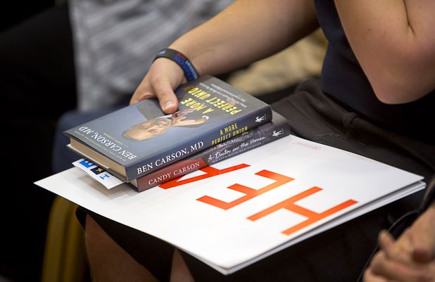 A member of the audience holds books by Republican presidential candidate Ben Carson during Carson's campaign stop at the Mountain Shadows Community Center in Summerlin Tuesday, Feb. 23, 2016.