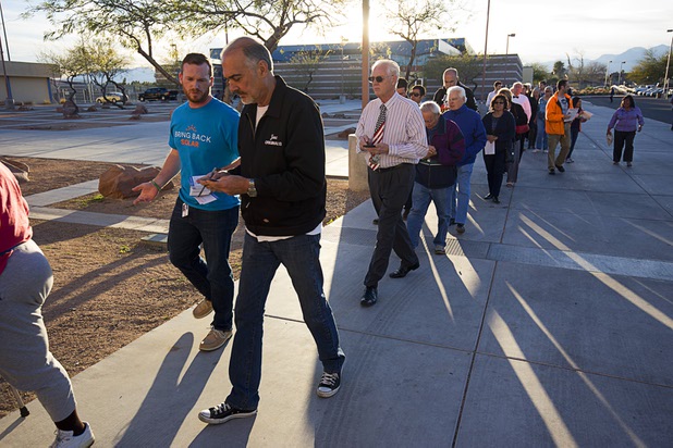 Caucus-goes line up at the Western High School GOP caucus site Tuesday, Feb. 23, 2016.