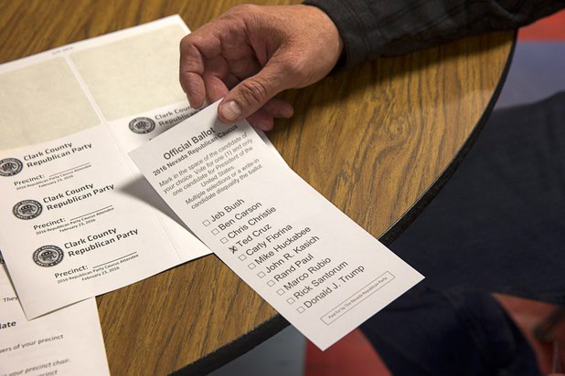 A Ted Cruz supporter holds his ballot at the Western High School GOP caucus site Tuesday, Feb. 23, 2016.