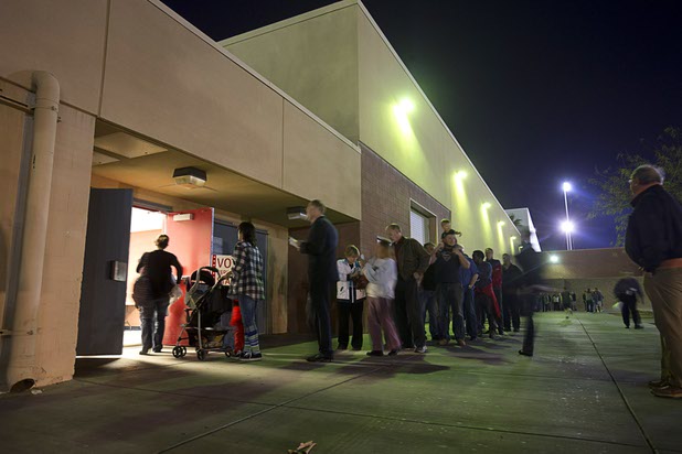 People wait in line outside the Western High School GOP caucus site Tuesday, Feb. 23, 2016.