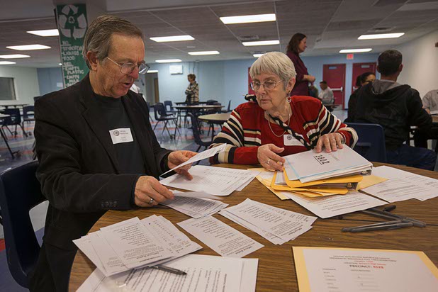 Volunteers Calvin Border and Marsha Lynch count ballots Tuesday, Feb. 23, 2016, at the Western High School Republican caucus site. 