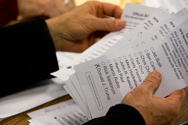 Volunteer Calvin Border counts ballots Tuesday, Feb. 23, 2016, at the Western High School Republican caucus site.