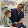 Dr. Jay Fisher examines Bruce, a 3-year-old patient who hit his head on a tile floor.