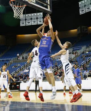 Bishop Gorman center Zach Collins (12) shoots against Coronado's Jake Desjardins (24) and Trey Hurlburt (1) during the state championship game at the Lawlor Events Center on the campus of UNR, Friday, Feb. 26, 2016.