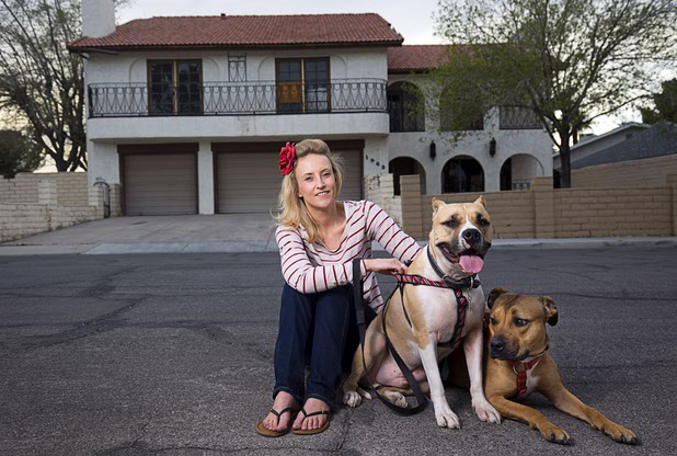 Paige Gordon, along with pit bulls Ziggy, left, and Ava, keep an eye on vacant properties in her neighborhood Sunday, Feb. 28, 2016. STEVE MARCUS