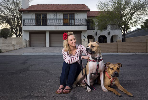 Paige Gordon, along with pit bulls Ziggy, left, and Ava, keep an eye on vacant properties in her neighborhood Sunday, Feb. 28, 2016. STEVE MARCUS