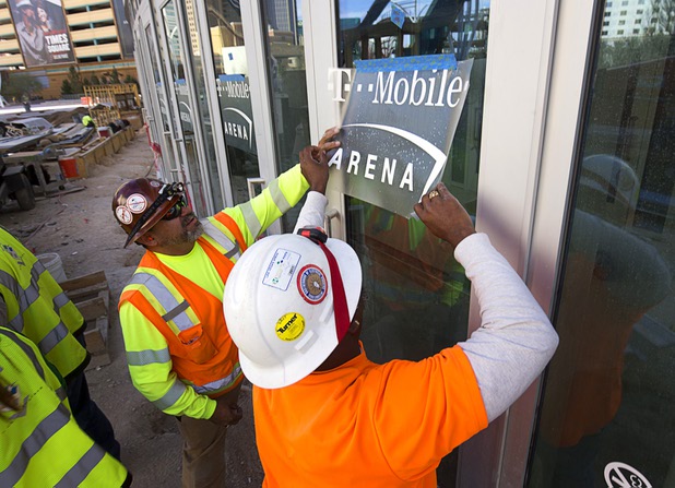 Works put signage on the doors of the T-Mobile Arena Tuesday, March 1, 2016. The 20,000-seat arena, a joint venture between AEG and MGM Resorts, is scheduled to host it's first event on April 6.
