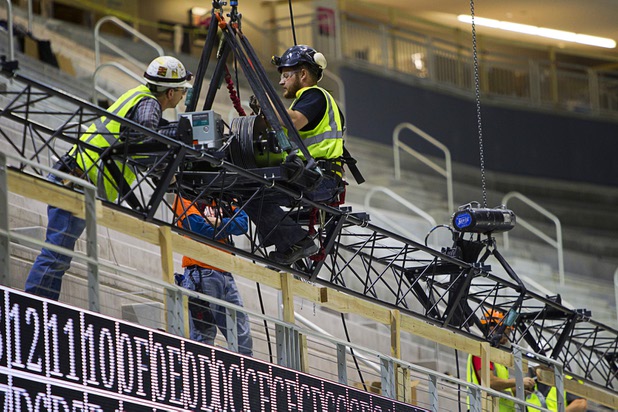 Workers prepare to lift some rigging during construction of the T-Mobile Arena Tuesday, March 1, 2016. The 20,000-seat arena, a joint venture between AEG and MGM Resorts, is scheduled to host it's first event on April 6.